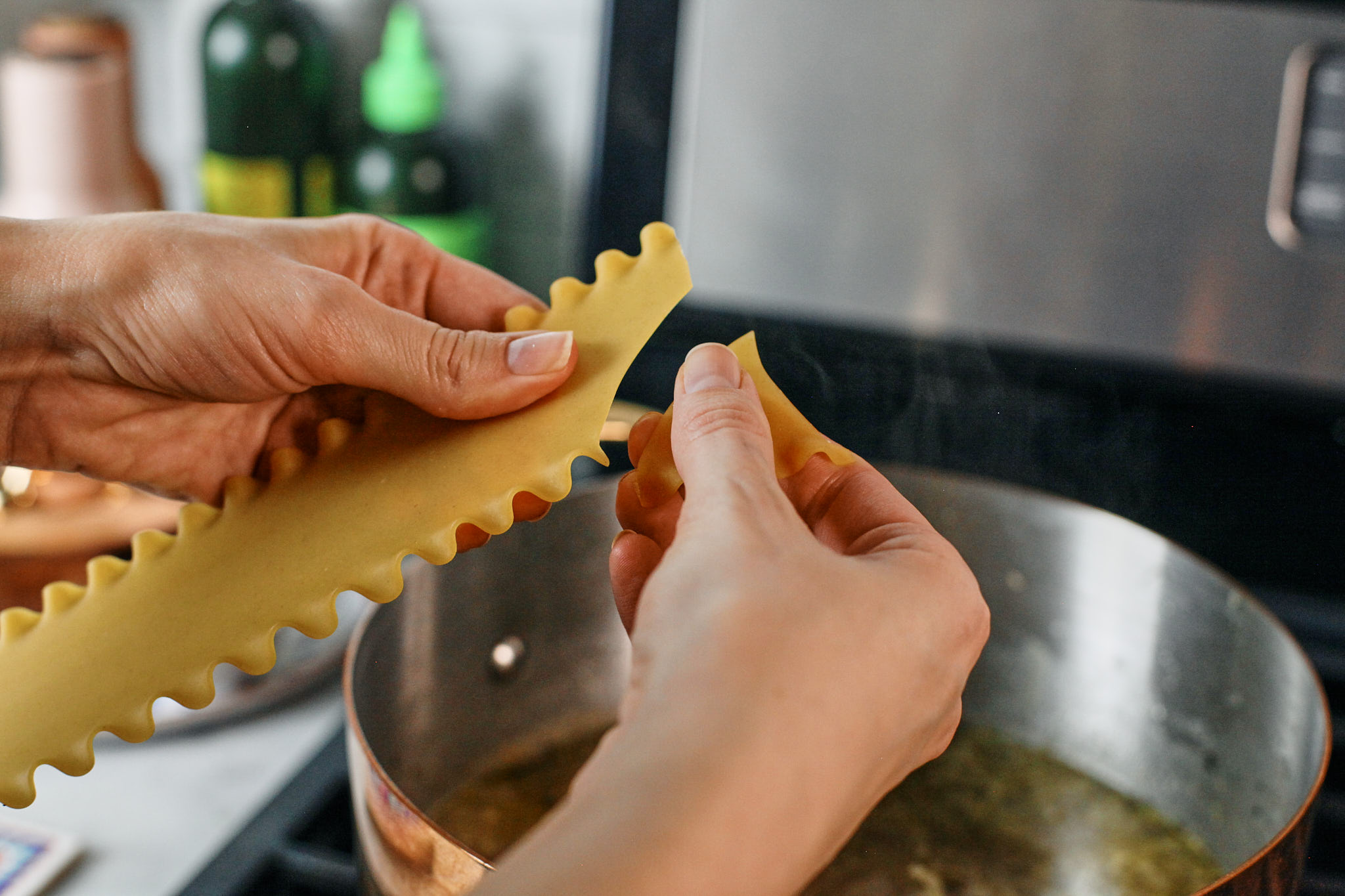 breaking pieces of lasagne into the creamy chicken lasagna soup