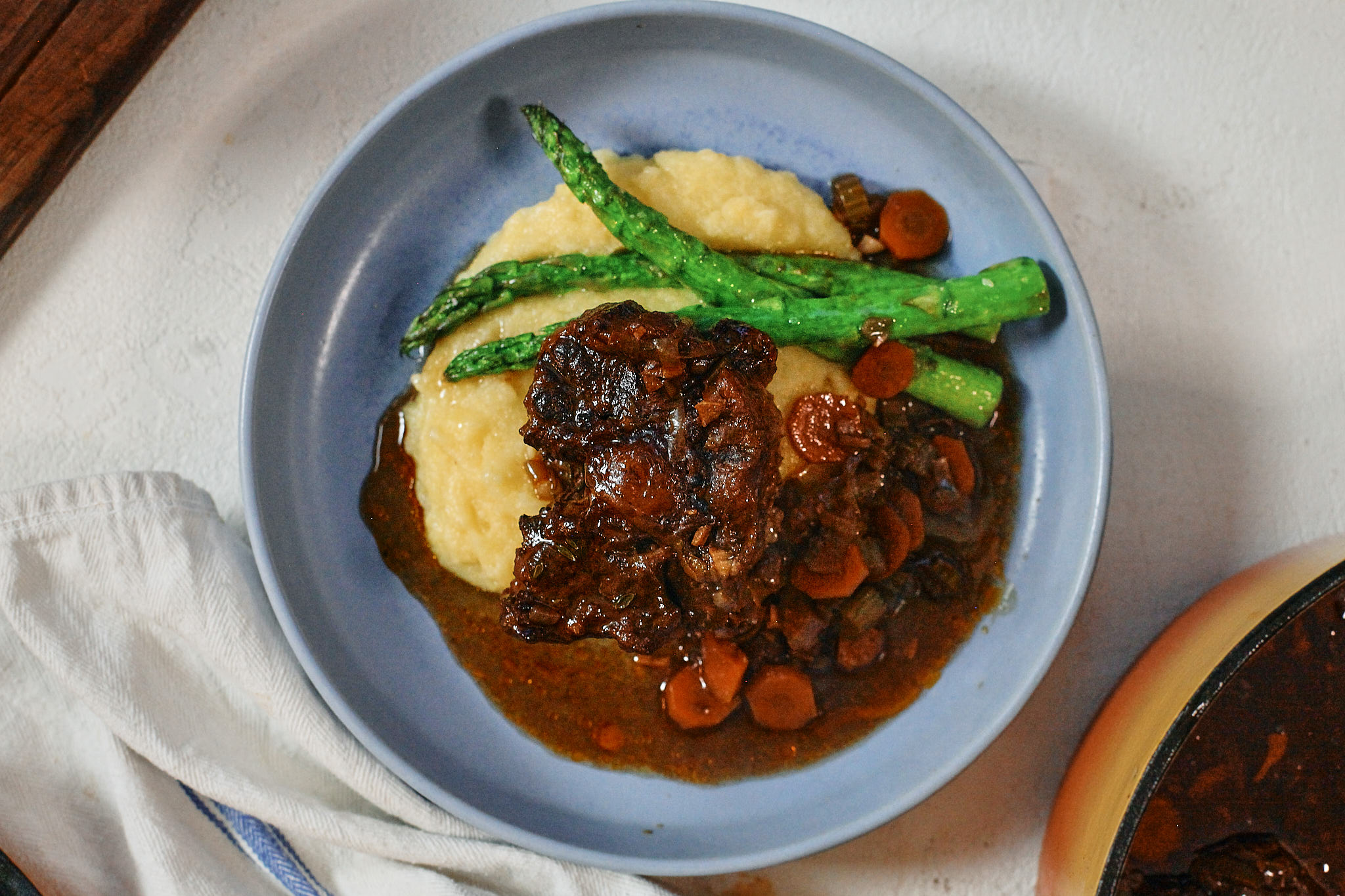 Ox Tail 10 braised oxtail over a bed of polenta with asparagus