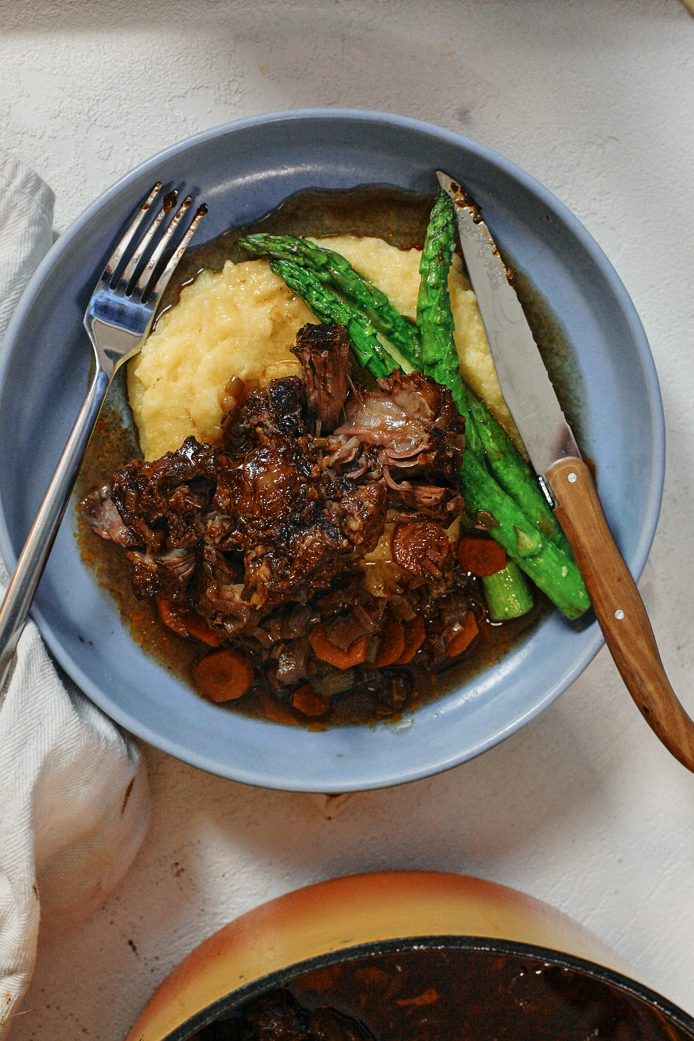 Ox Tail 12 braised oxtail over a bed of polenta with asparagus