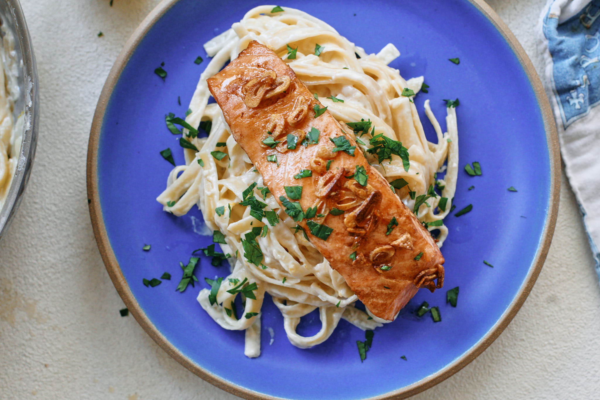 garlic butter salmon over creamy lemon pasta