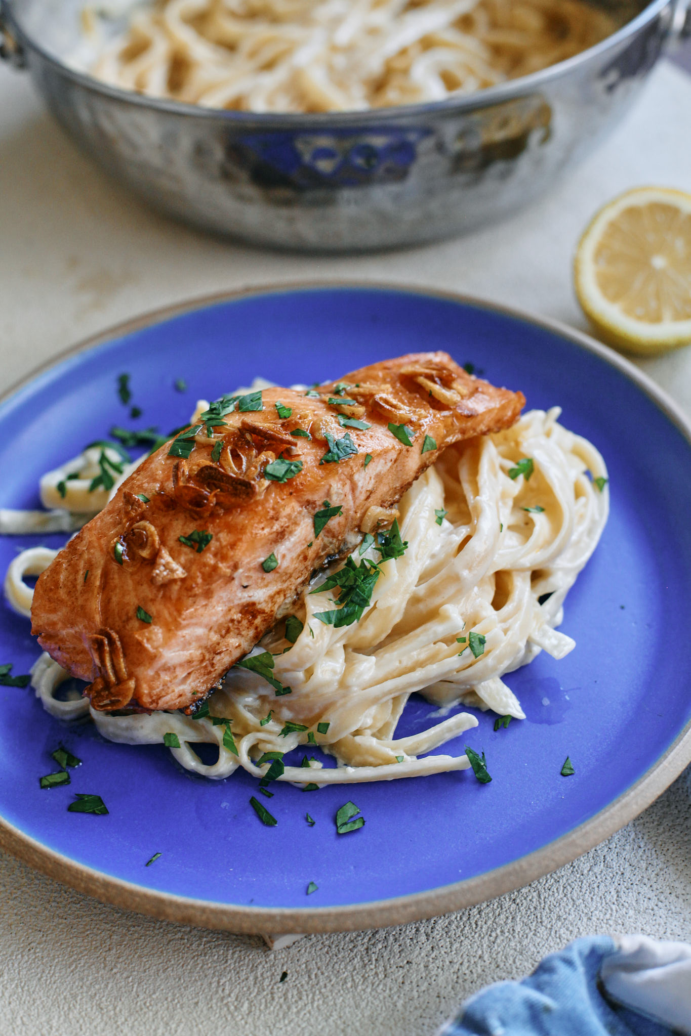 garlic butter salmon over creamy lemon pasta