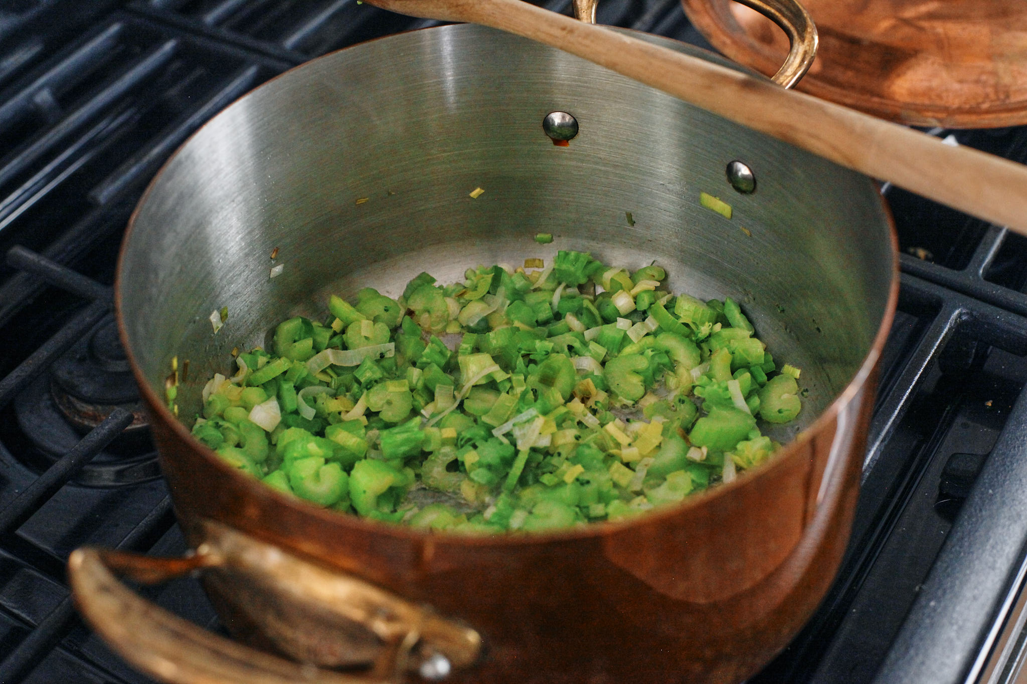 green goddess tortellini soup 1 greens sautéeing in the pot