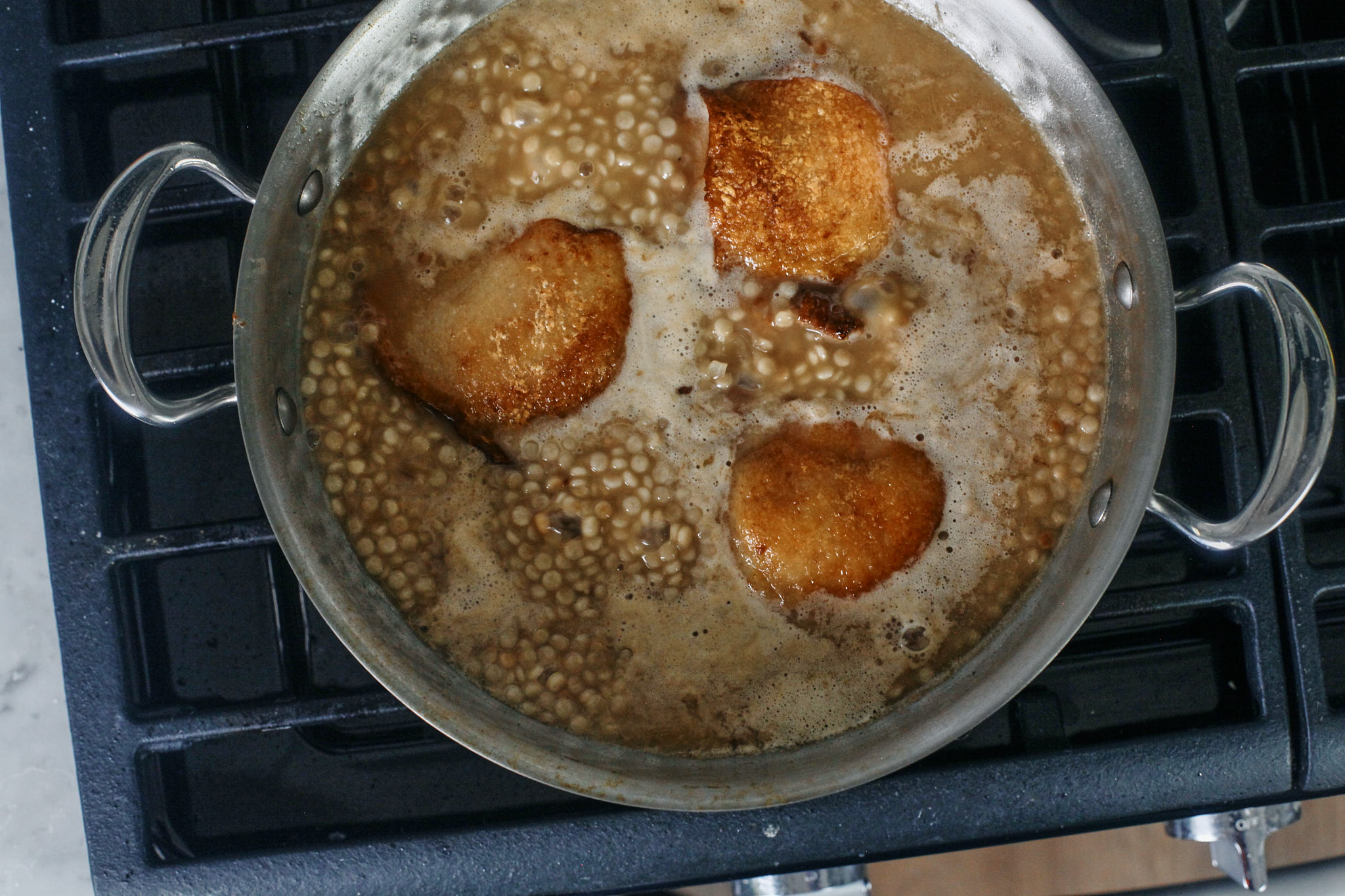 Creamy Boursin Chicken 11 chicken thighs finishing cooking in the pearl couscous