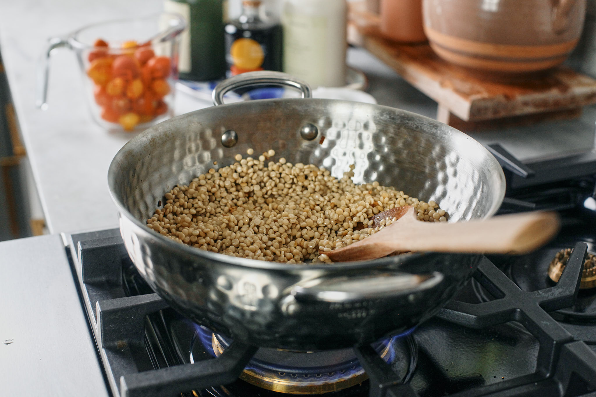 Lemon chicken florentine meatballs with couscous 9 pearl couscous cooking on the stove