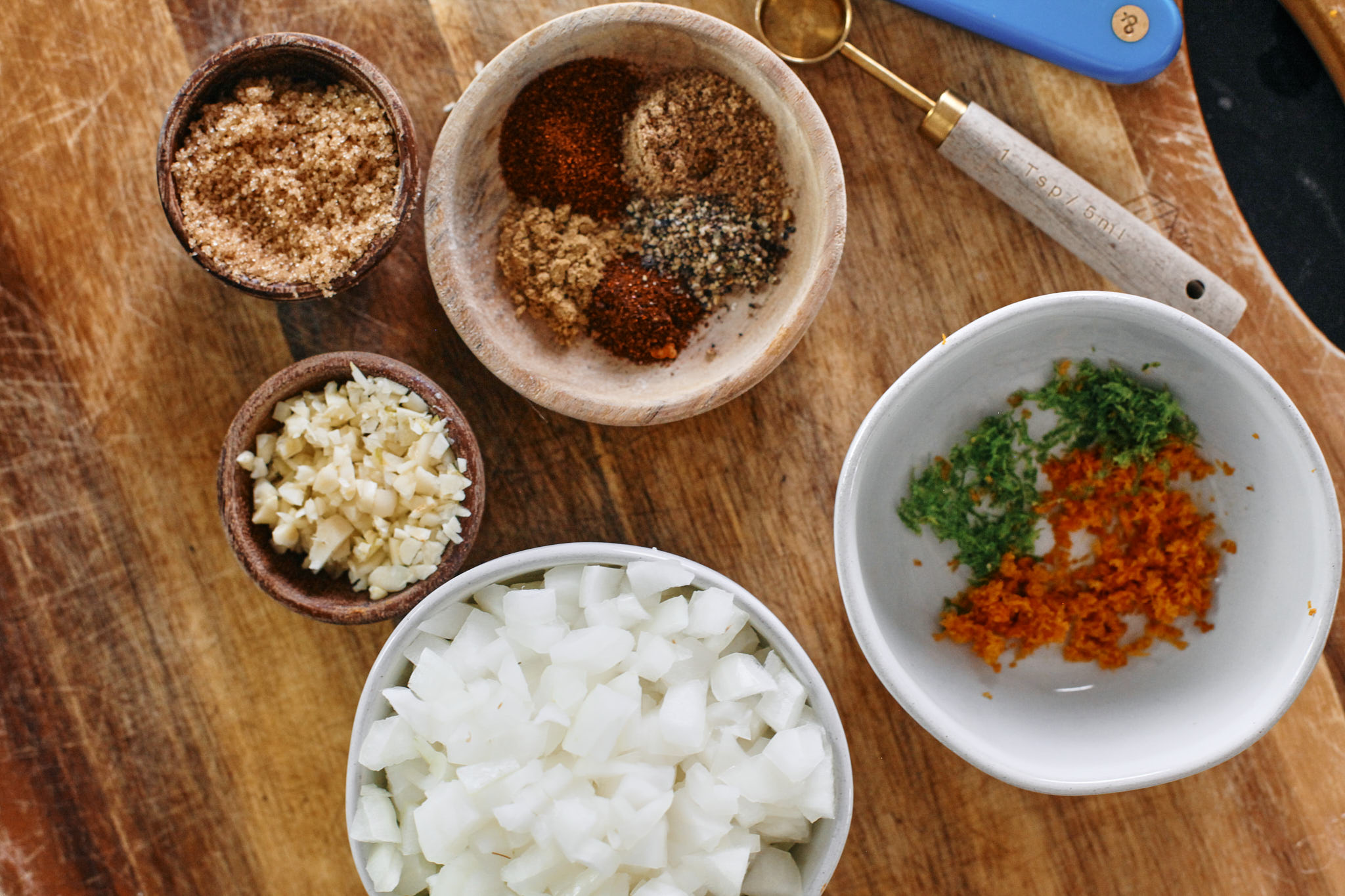 brown sugar, minced garlic, chopped onion, seasonings, orange and lime zest
