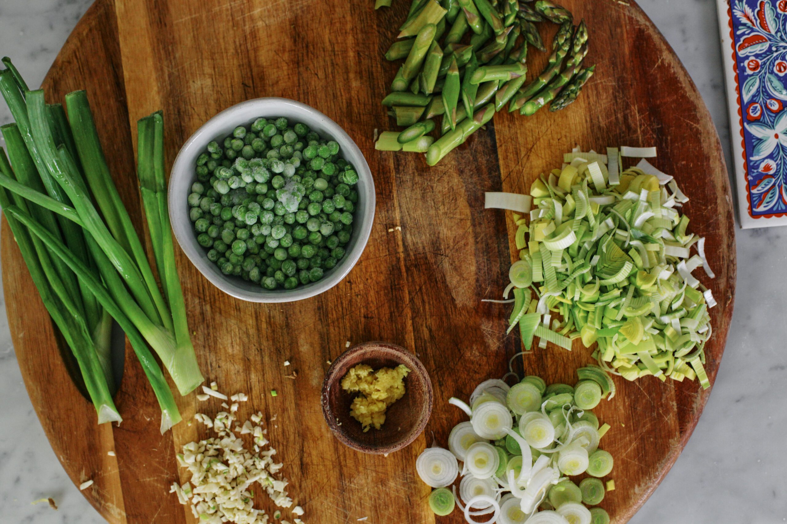 prep for the spring ginger chicken noodle soup: green onion, asparagus, peas, ginger, garlic and chopped leeks