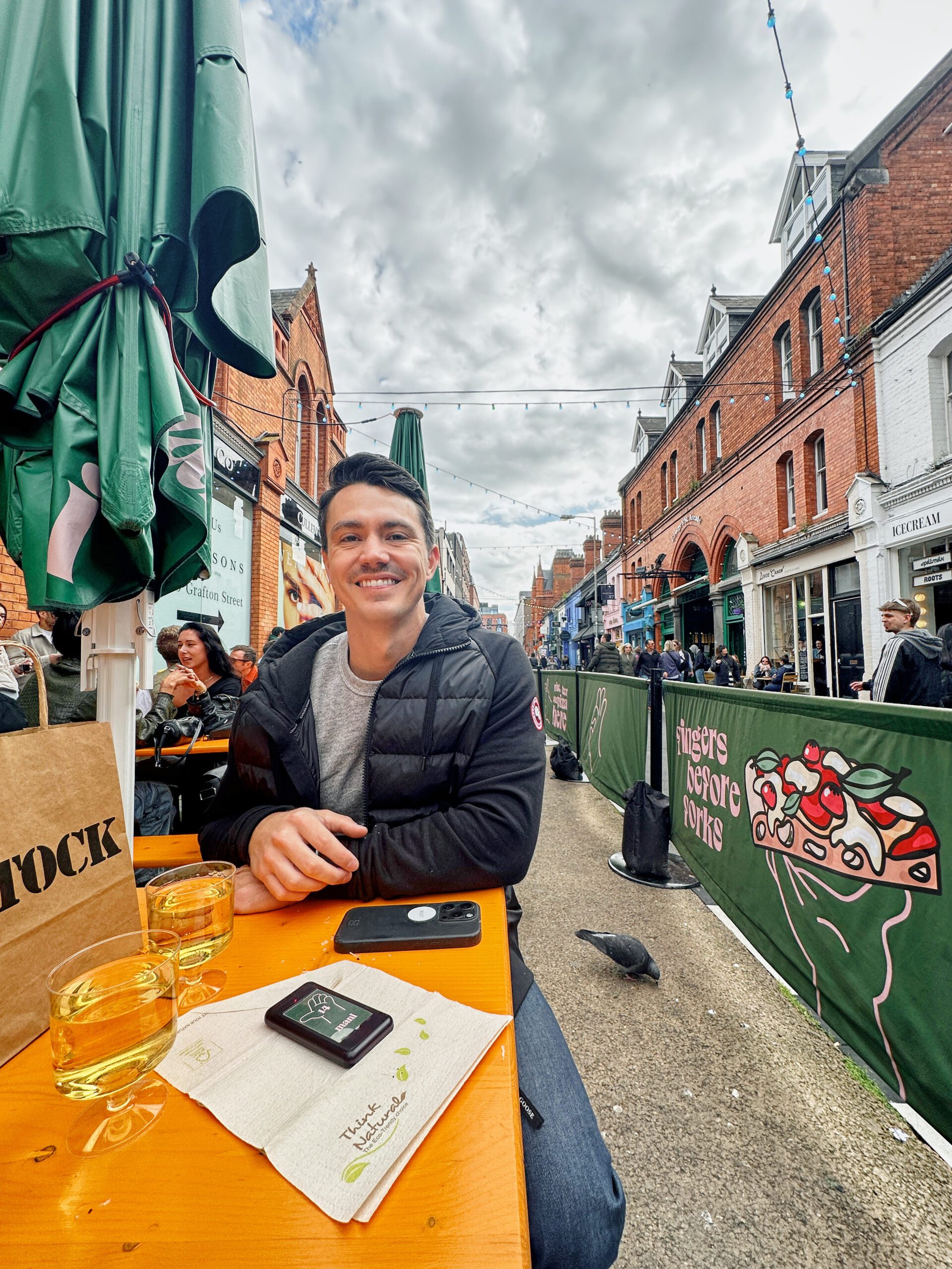 my husband Evan at an outdoor table at Mani Pizza