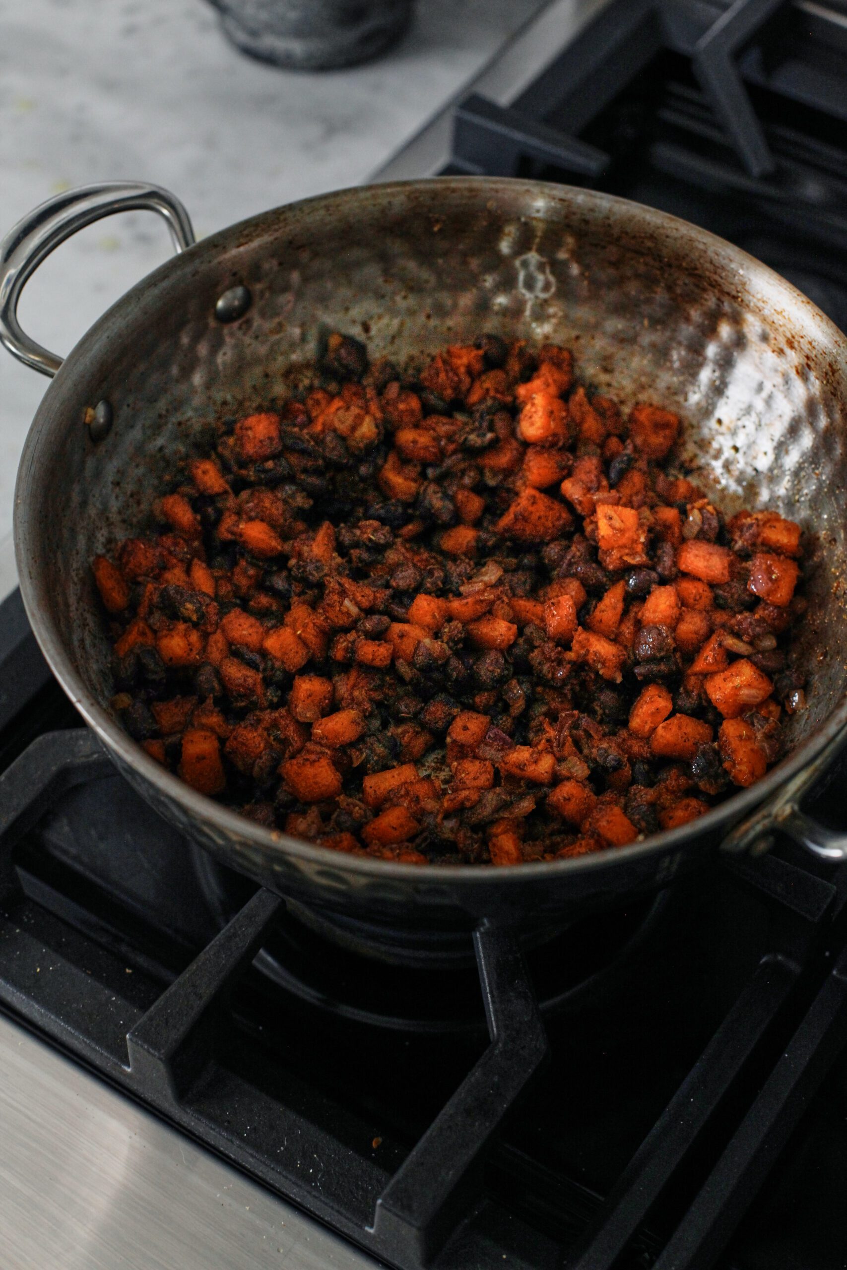 sweet potato and black beans sautéing in a pan
