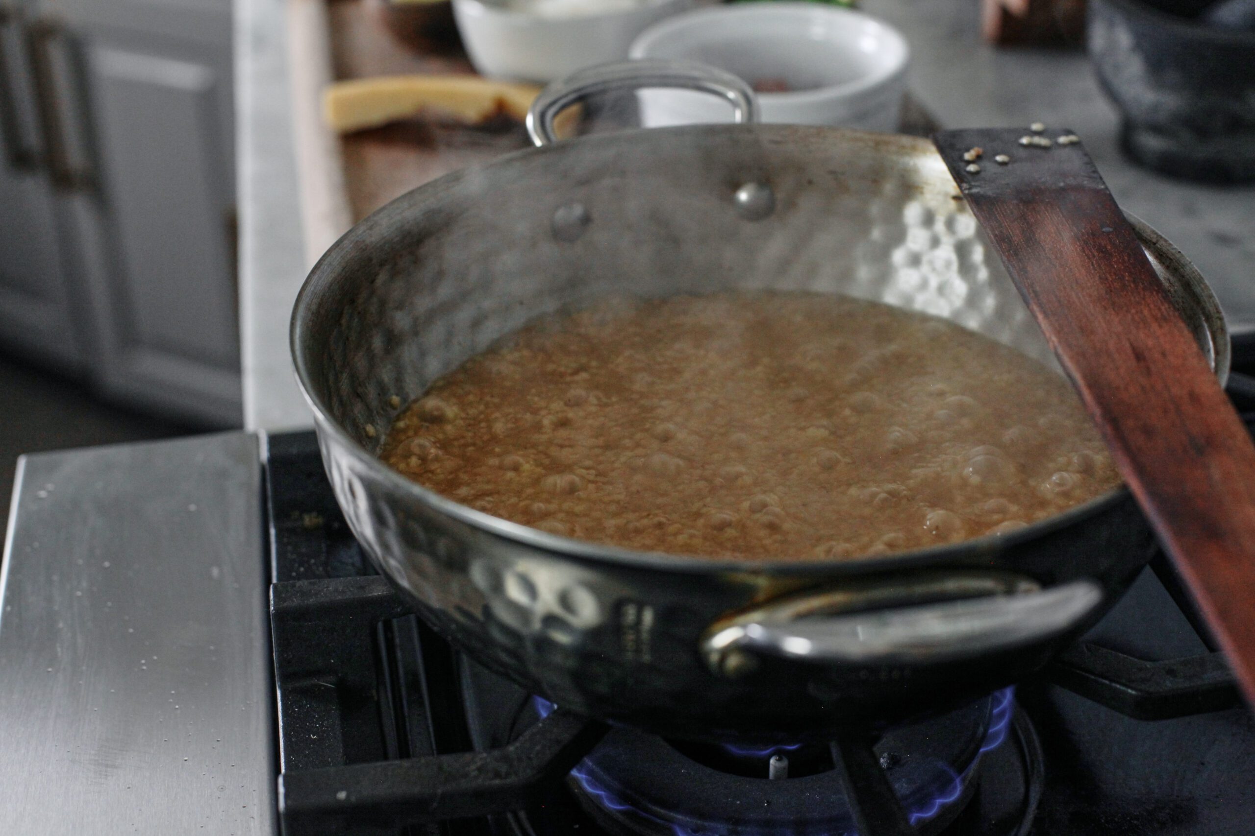 pastina + broth simering in a pan over the stove