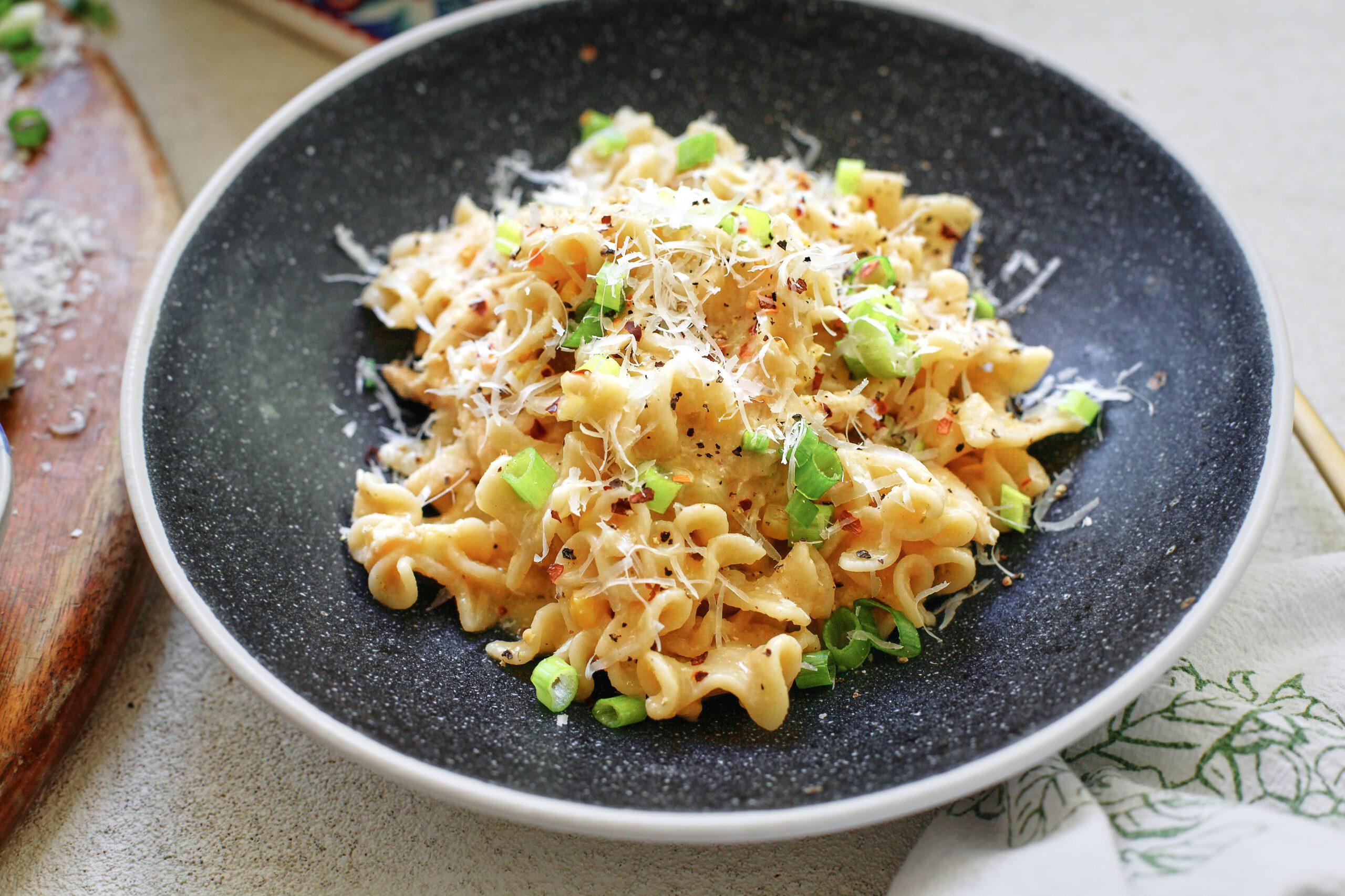 creamy corn and chicken pasta in a charcoal-coloured bowl