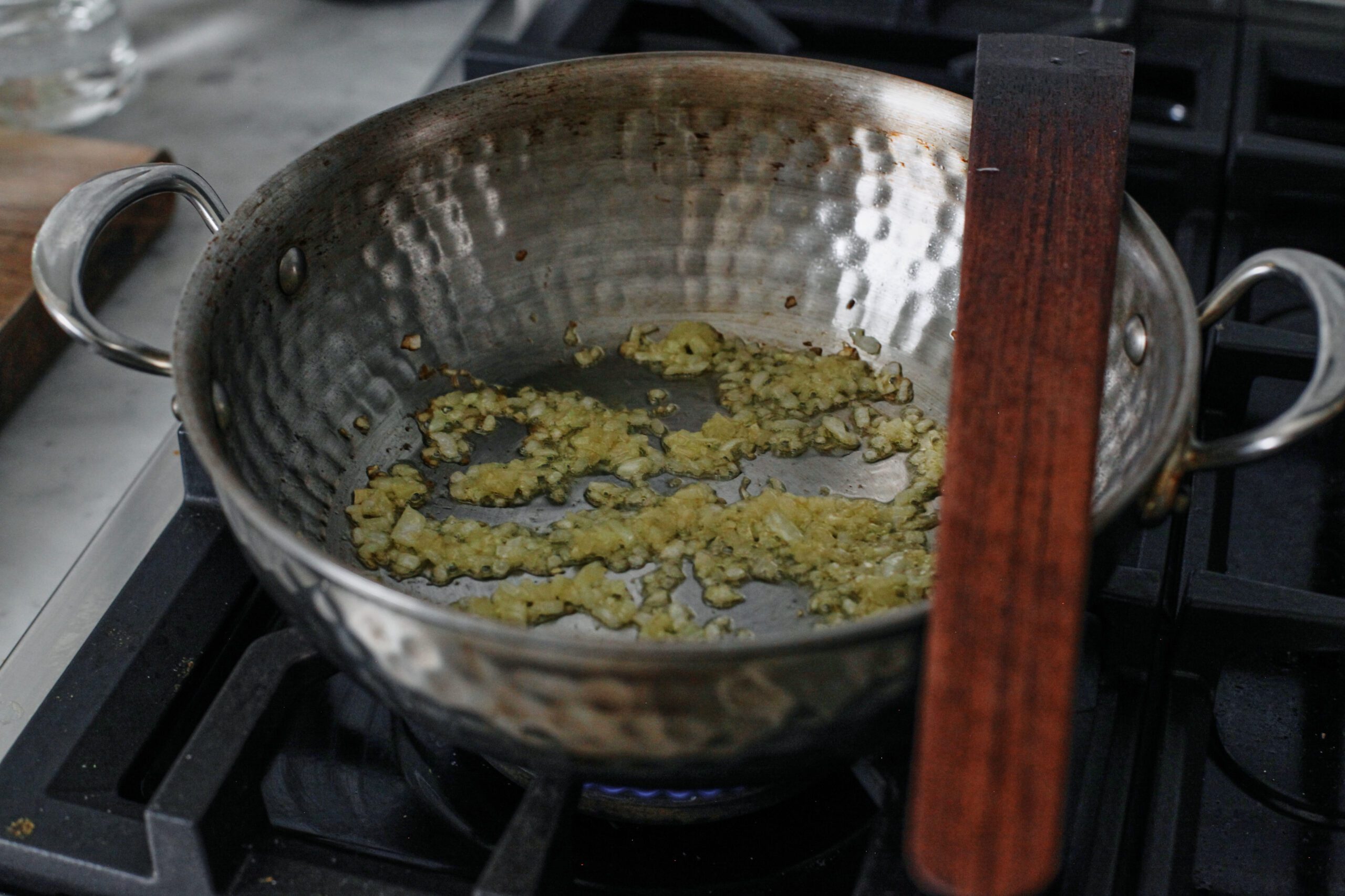 chili oil penne alla vodka 7 onion being sauteed in a pan on the stove