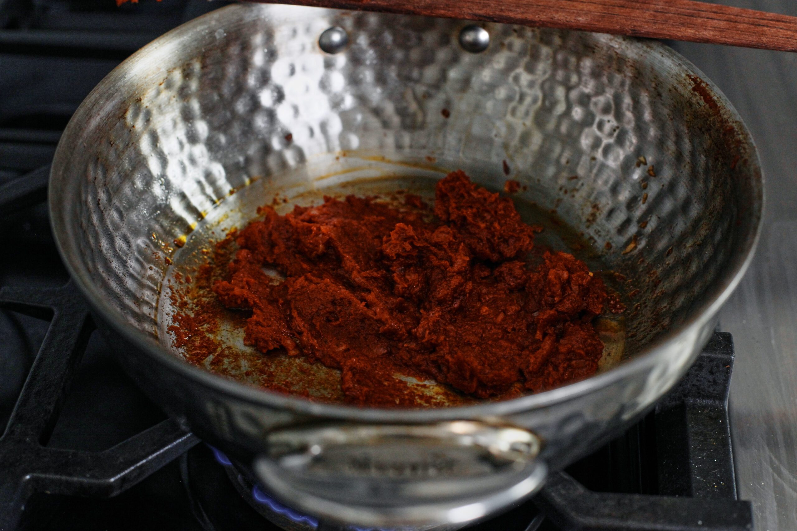 chili oil penne alla vodka 9 tomato paste being cooked in a pan