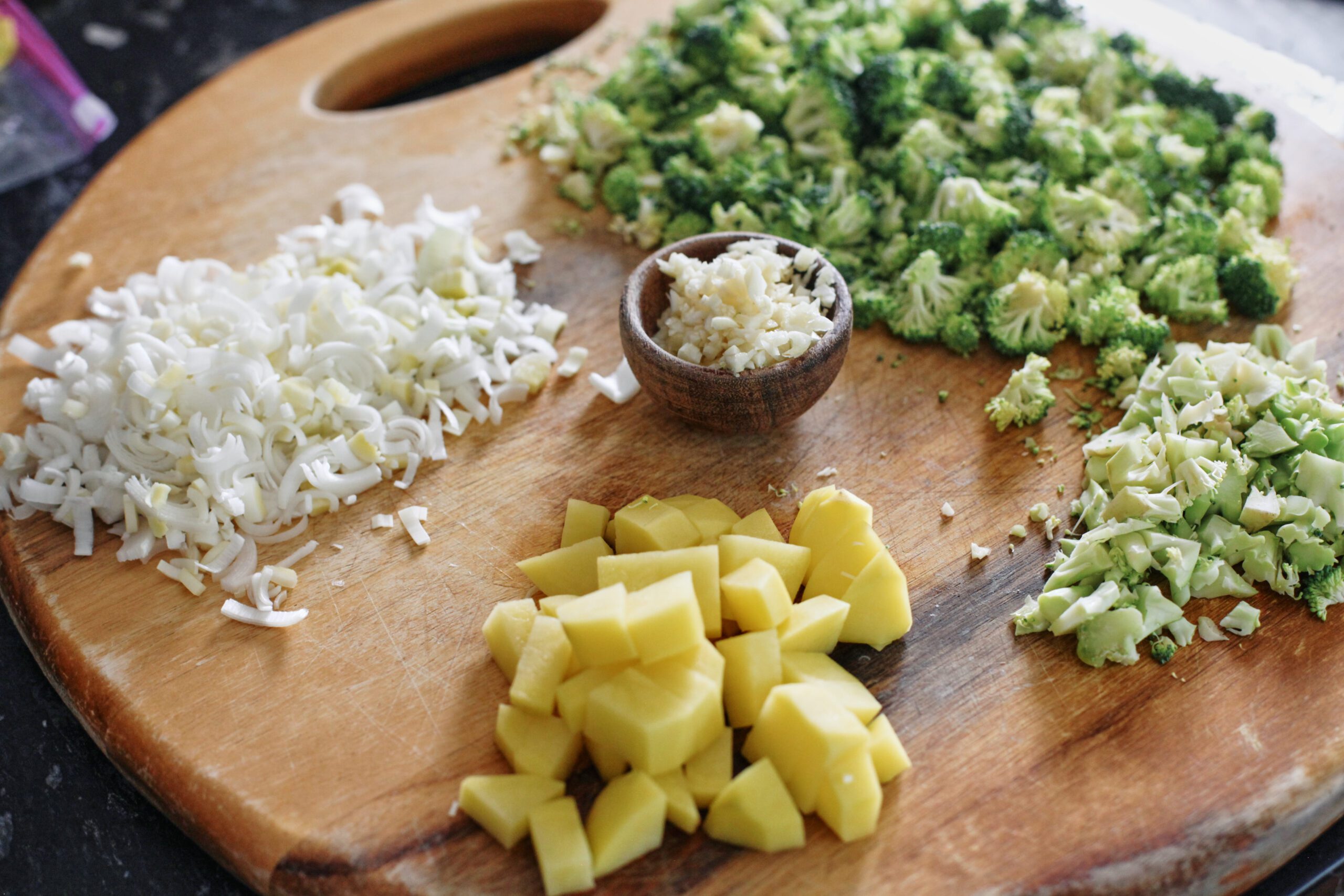 Broccoli Cheddar Orzo Soup prep for the broccoli cheddar orzo soup: chopped leek, broccoli florets, broccoli stems, potato, garlic