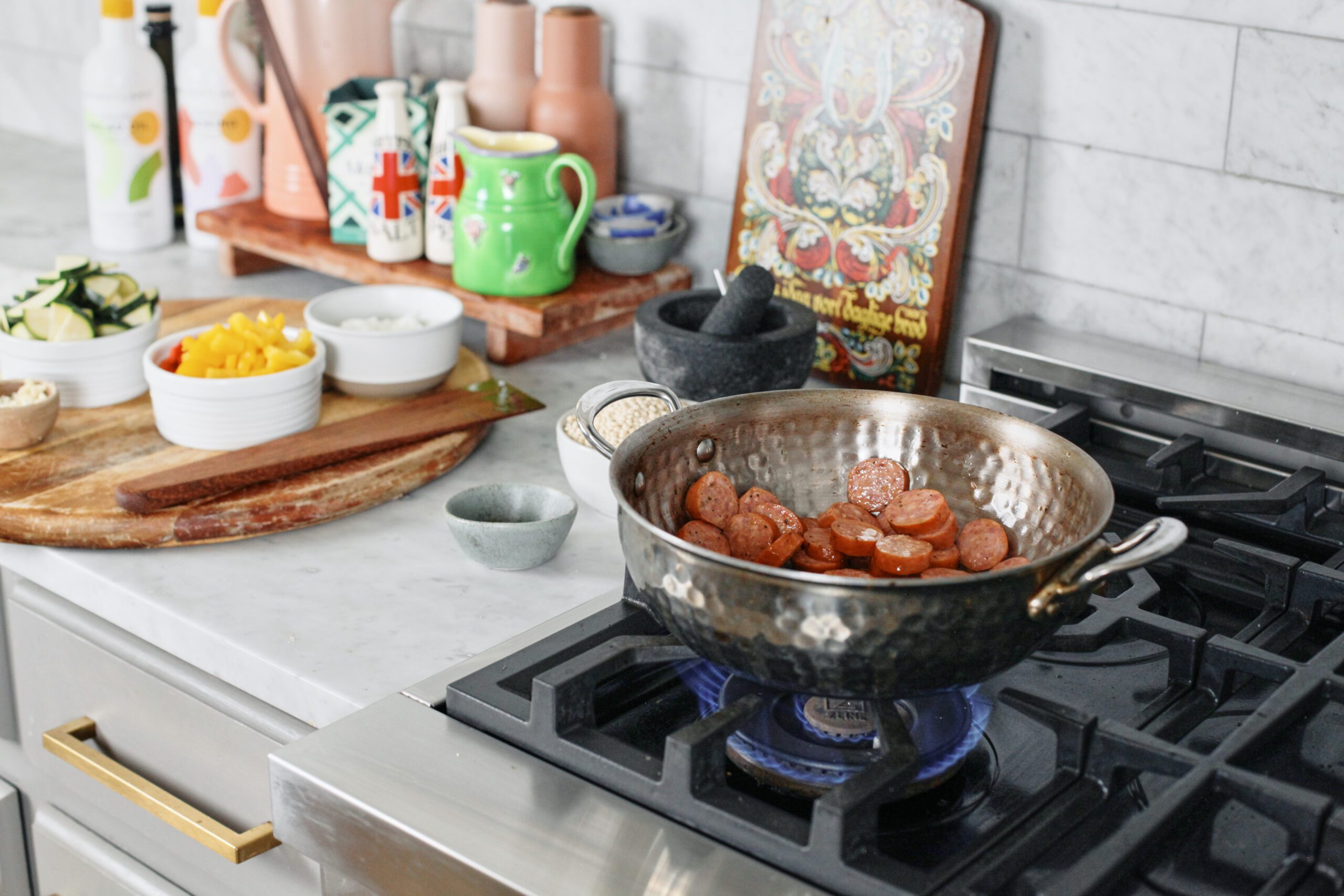 sliced sausage being sautéed
