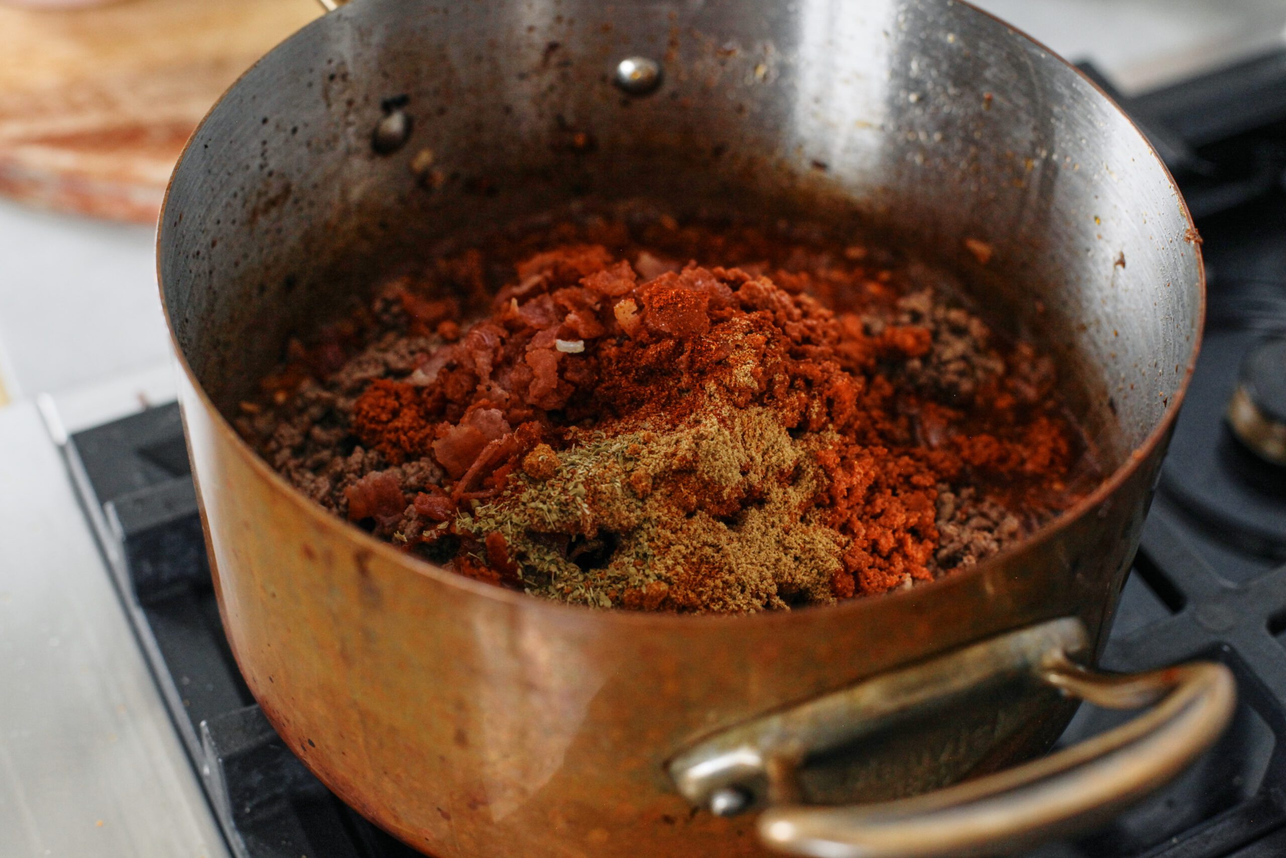 meat and spices added into the pot