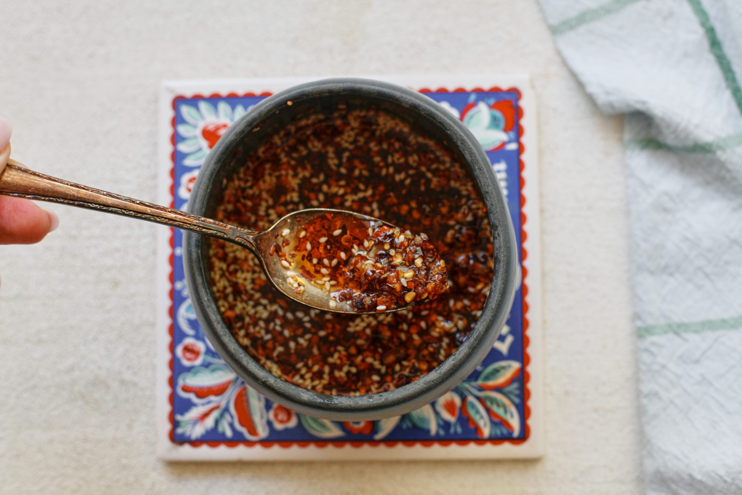 Wonton Soup 29 chili oil in a small grey bowl with a gold spoon