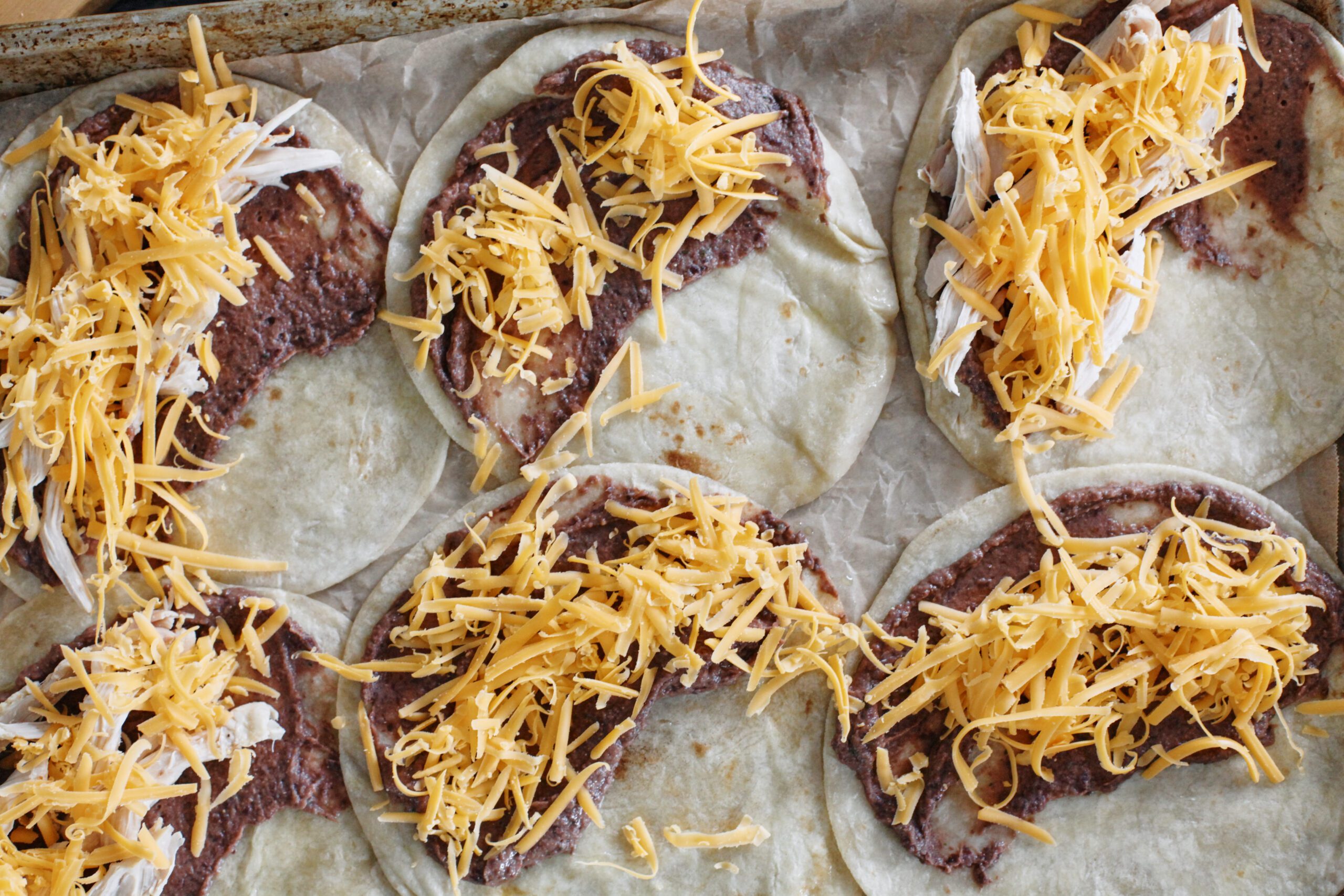 cheese and black bean puree on six tortillas